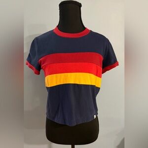 Marine Layer navy T-shirt with red collar and yellow stripe detail.